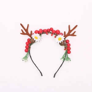 Christmas reindeer antler headband with red berries and pine cones on white background