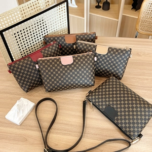 Classic monogram crossbody square bag in multiple colors displayed on a wooden table