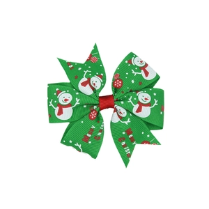 Detail of Christmas bow hair clip with snowman patterns and Merry Christmas text