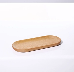 Macro view of the natural solid wood oval jewelry tray with smooth textures and grain