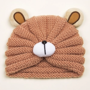 Close-up of winter baby knitted bear hat showing thick warm yarn texture and fuzzy ears