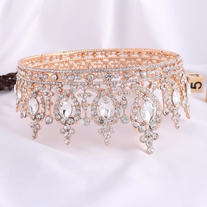 Close-up of rose gold bridal crown with sparkling teardrop and round rhinestones