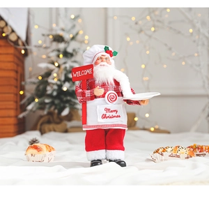 Close-up of chef Santa Claus figurine holding a Welcome sign with festive bokeh background