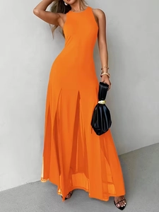 Detail view of bright orange sleeveless maxi dress with slit hem and pleated texture