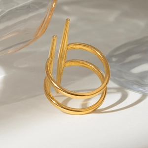 Detailed close-up of a gold double-layer open geometric ring with spiked pillar design