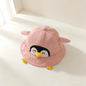 Close-up detail of a cute pink penguin-themed cotton bucket hat for baby girls and boys.