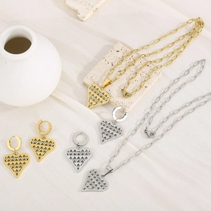 Detailed view of hollow heart jewelry set with sparkling rhinestones in gold and silver