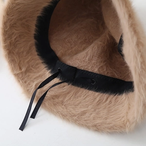 Detail shot of camel faux fur bucket hat featuring internal adjustable drawstring cord