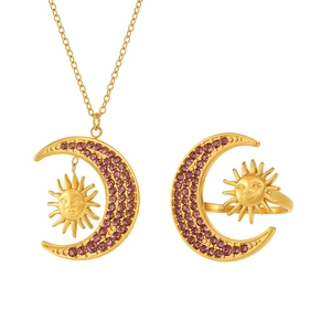 Gold celestial jewelry set featuring sun and crescent moon motifs with purple crystals
