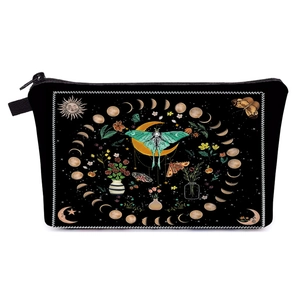 Detailed view of black fabric cosmetic bag featuring lunar phase and moth patterns
