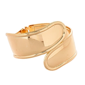 Polished gold wide metal cuff bracelet with irregular overlapping design on white background