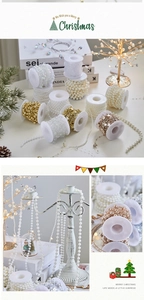 Detail of Christmas tree bead chains with star sequins on rolls for festive decoration