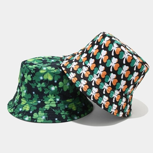Close-up of foldable shamrock fisherman hats in black and green clover patterns