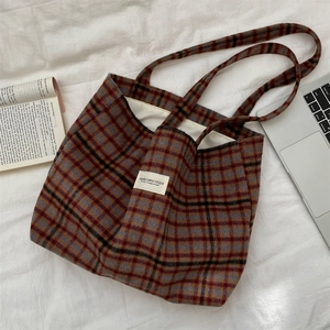 Detail of red and blue vintage plaid wool tote bag with white SHIAKKA woven label