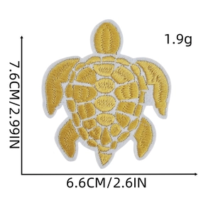 Close-up of golden sea turtle embroidery patch showing detailed texture and measurements