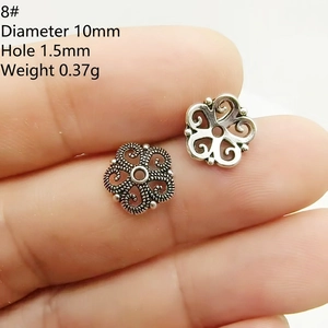 Macro view of 10mm silver flower petal bead spacer showing diameter and 1.5mm hole