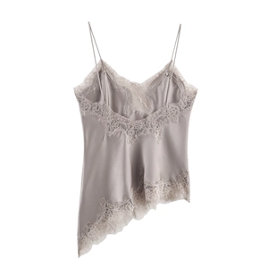 Detail of grey silk camisole featuring delicate eyelash lace trim and asymmetric hemline