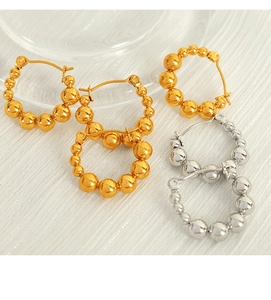 Detail of geometric round earrings with gradient metal beads in gold and silver finish