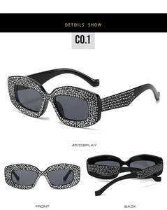 Detail view of rhinestone cat-eye sunglasses with sparkly crystals on black frames