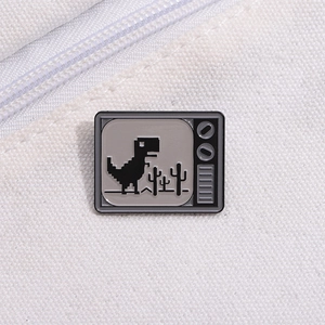 Macro shot of vintage television enamel pin with pixel dinosaur on white canvas bag