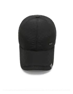 Macro detail of black quilted baseball cap with diamond pattern and ear protection for winter