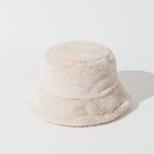 Close-up of soft beige faux fur texture on a warm winter bucket hat for women
