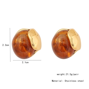 Detail view of amber resin stud earrings with stainless steel gold-plated frames and size