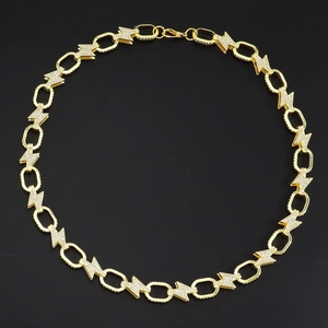 Close-up of golden lightning bolt chain necklace with sparkling crystal rhinestones