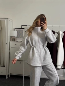 Women's grey two-piece tracksuit with zip-up drawstring hoodie and matching sweatpants