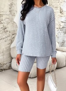 Detail showing the gray vertical striped knit texture on this casual two-piece outfit