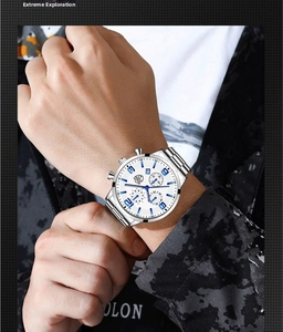 Detail view of a men's silver stainless steel watch with a blue numeric dial on wrist