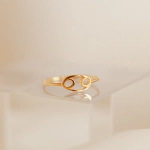 Minimalist gold-plated stainless steel Cancer zodiac sign open ring on acrylic stand