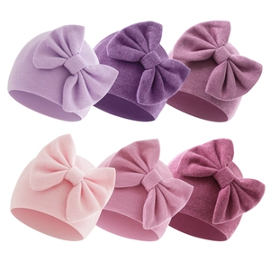 Six-piece infant rib-knit beanie set with large bows in varied shades of pink and purple