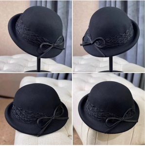 Detail view of black vintage wool felt pillbox hat with lace mesh belt and bow decoration