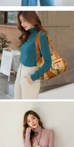 Detail of vintage multi-pocket shoulder bag in brown faux leather with rivet accents