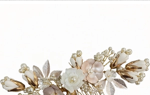 Macro detail of bridal hair comb with ceramic flowers, faux pearls and golden leaves
