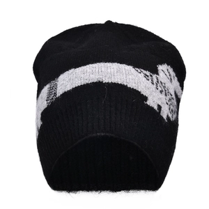Detailed view of black knitted beanie featuring white sausage dog jacquard patterns