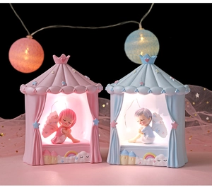Close-up of resin tent night lights with angel figurines and dreamy LED star lighting