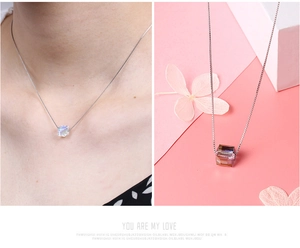 Macro detail of S925 silver necklace featuring a sparkling iridescent cube crystal pendant