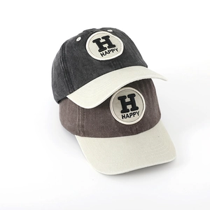 Close-up of Happy letter embroidery and washed cotton texture on kids baseball caps
