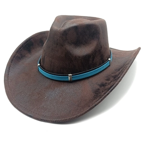 Detail of vintage brown suede cowboy hat with blue and black buckled leather band
