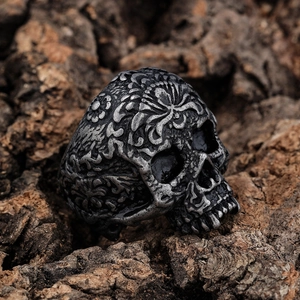 Vintage punk skull ring in oxidized silver finish with intricate floral carvings on wood
