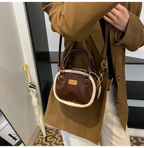 Detail of crossbody pillow bag featuring brown PU leather and white faux shearling trim