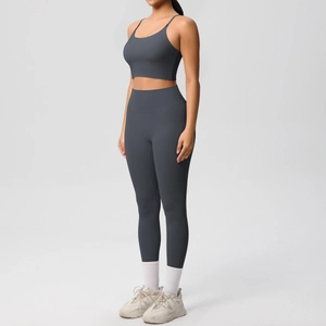 Detail of dark grey yoga set featuring thin strap sports bra and high waist leggings