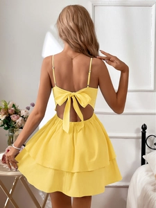 Detail of summer dress featuring a large bow on an open back with thin straps