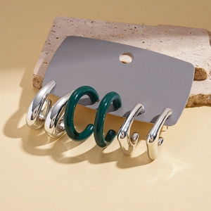 Detailed view of six-piece geometric acrylic and silver needle earrings set in green and silver