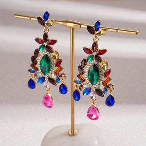 Close-up of luxury vintage drop earrings with colorful crystals and gold-tone finish