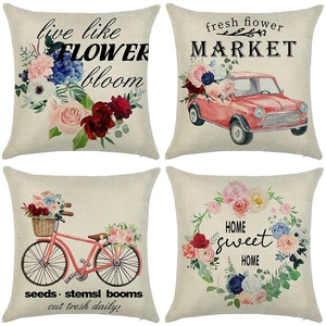 Set of four linen cushion covers featuring vintage floral designs and rustic typography