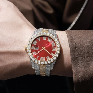 Macro view of iced out men's quartz watch with red roman dial and gold-tone diamond band