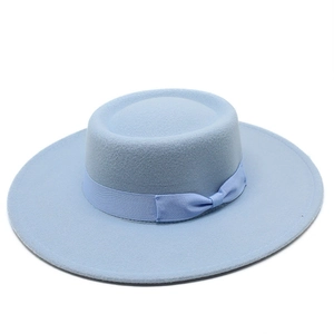 Top view of a light blue flat top wool felt boater hat with a matching ribbon bow detail